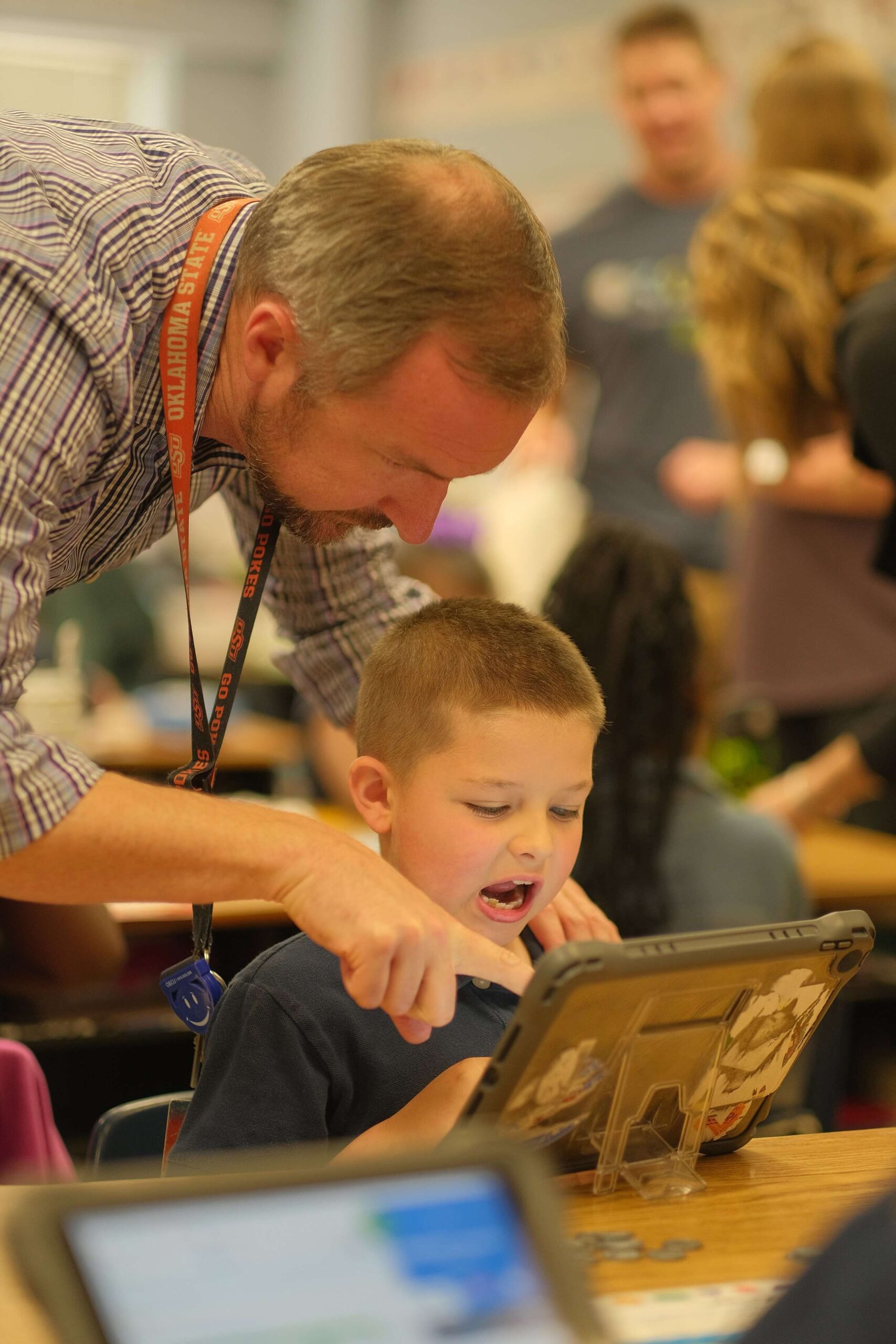 Seesaw administrator assisting a student on iPad