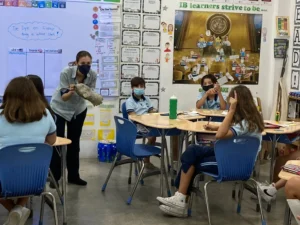 5th grade teacher demonstrating an activity in front of the class