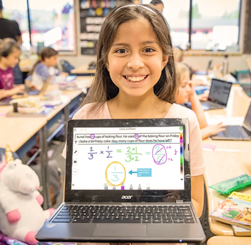 student holding laptop with Seesaw platform