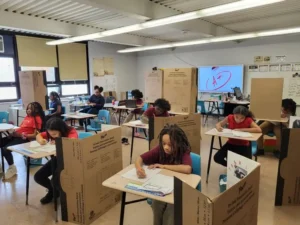 Elementary students working on a poster project